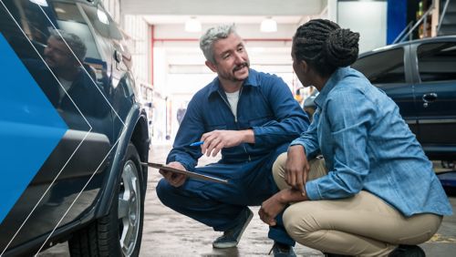 A mechanic consulting with a customer.
