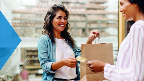 Woman using her Visa card to pay for shopping
