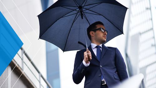 Banker under an umbrella on a rainy day.