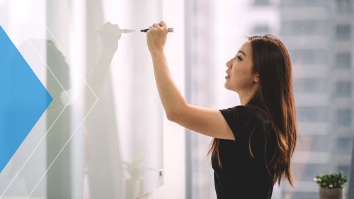 Woman writing on whiteboard