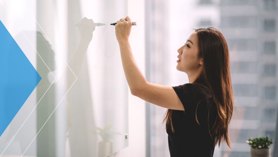Woman writing on whiteboard