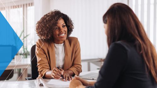 Banker discusses payment automation with business customer. 