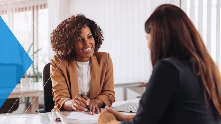 Banker discusses payment automation with business customer. 