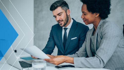 Business coworkers meeting about recent payables automation process changes. 