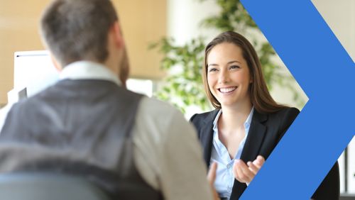 Two accounts receivable coworkers in office meeting.