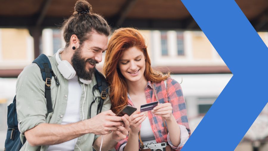 Young couple with smartphone and credit card making a mobile online purchase