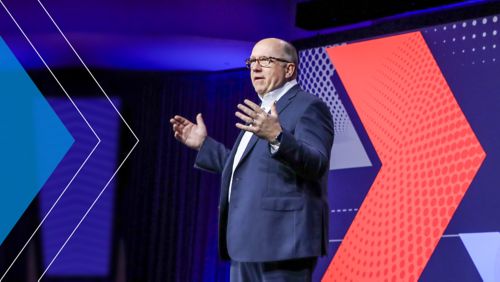 Barry C. McCarthy on a stage giving a speech.