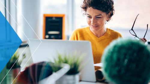 Nonprofit leader at her desk, browsing on her laptop.