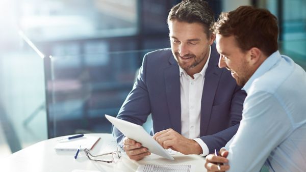 men looking at a document