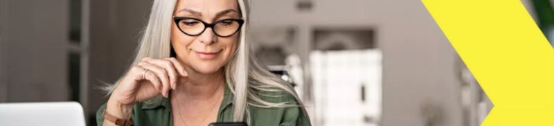 A woman wearing glasses working on a laptop