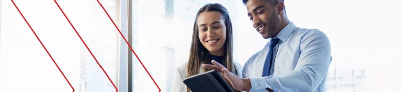 A businessman showing a coworker something on a tablet