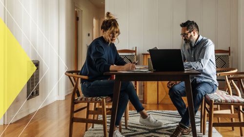 Couple sitting at home at their dining room table.