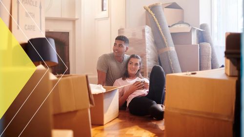 Two men walking down office stairs while reviewing information on tablet