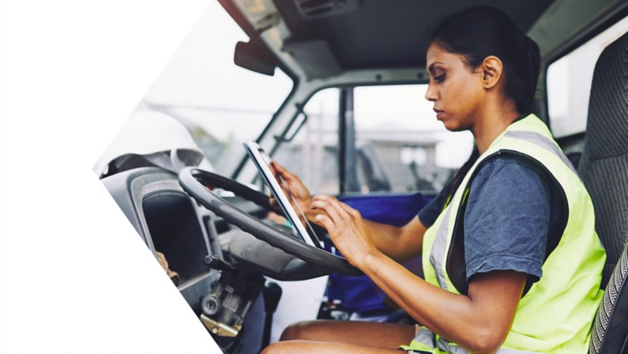 woman holding tablet in work vehicle