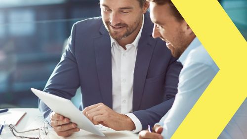 Two men looking at a tablet