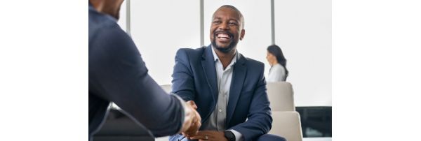 A man in a suit shakes hands with a banker