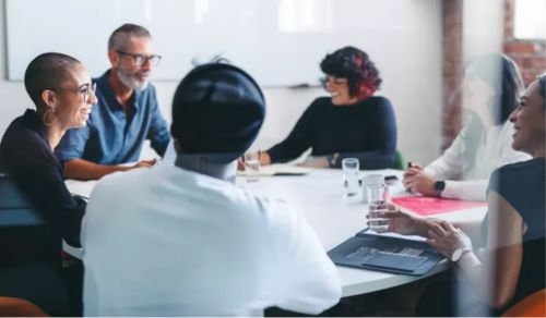 people in an office talking about supplier relationships