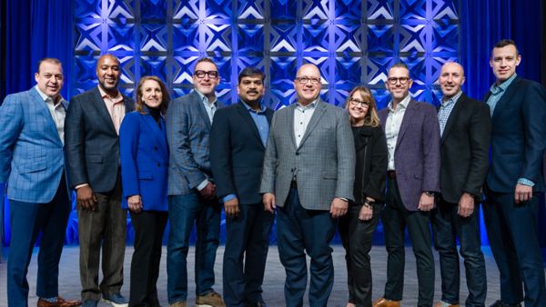 Deluxe leaders stand together for a photo