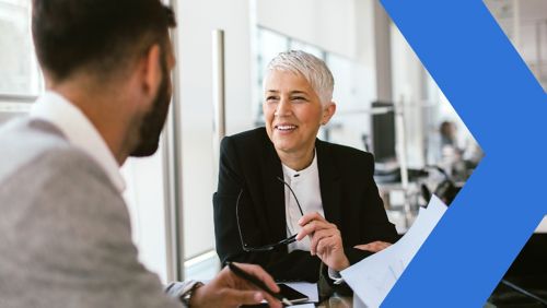 Female executive talking to colleagues in office. 