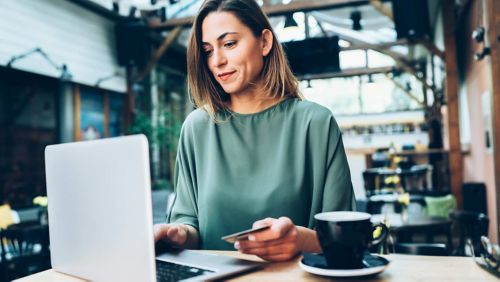 woman paying at computer with credit card