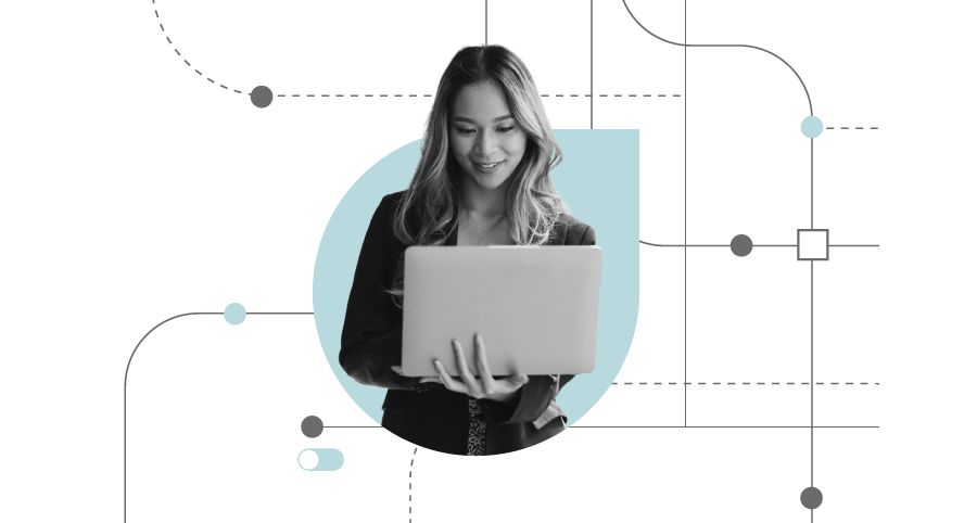 A woman holds a laptop analyzing digital accounts payable