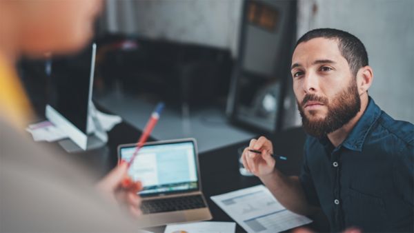 man looking at another person