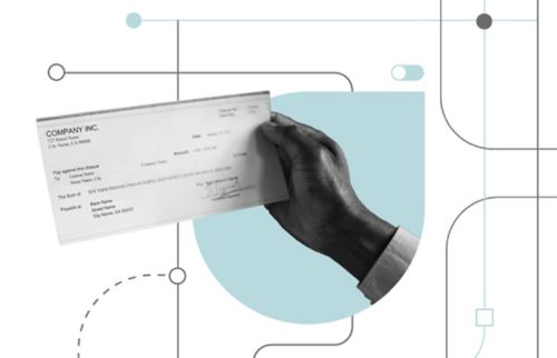 A hand holding a check