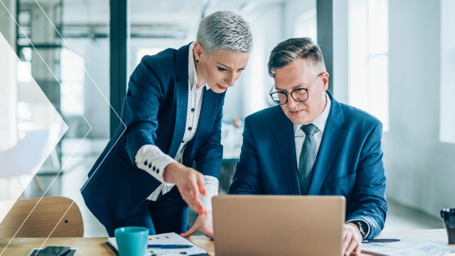 Two coworkers discussing The Changing Role of Treasury in Receivables