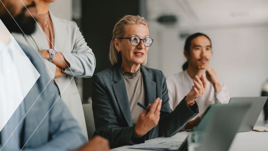 A woman having a conversation with another coworker 