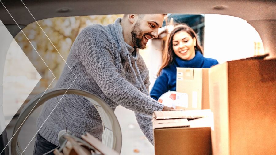 Two people packing a car trunk as though they were moving