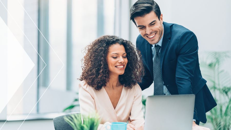 Two payment executives gathered around a computer