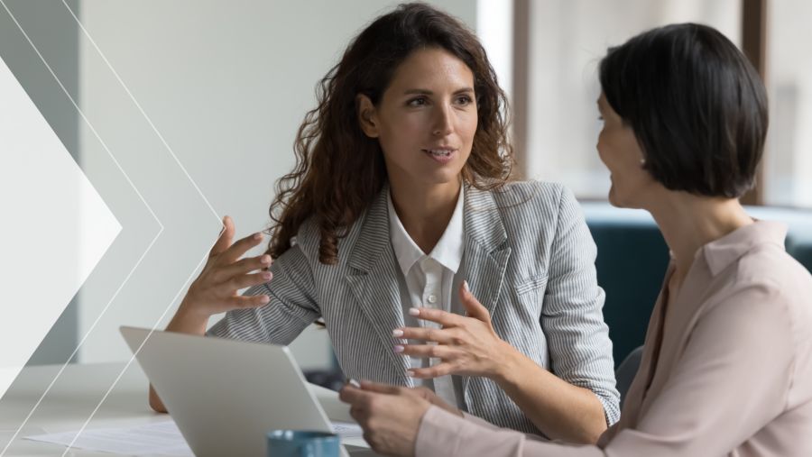 A woman having a conversation with another coworker 