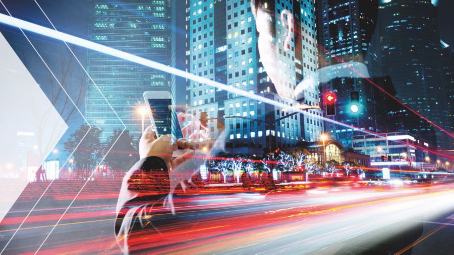 Tall buildings with an image overlay of a man using a cell phone. 