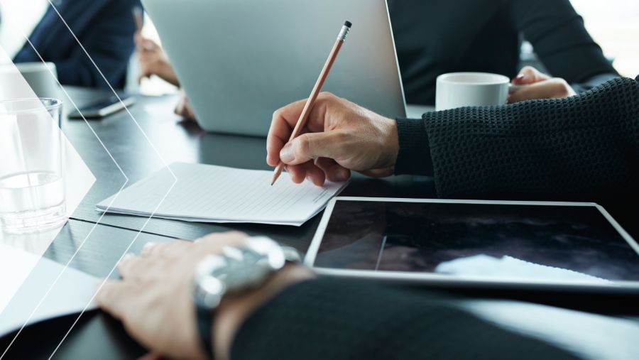 Close-up of CFO taking notes