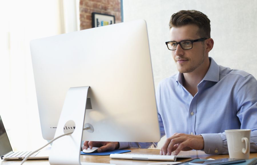 A businessman works at desktop computer