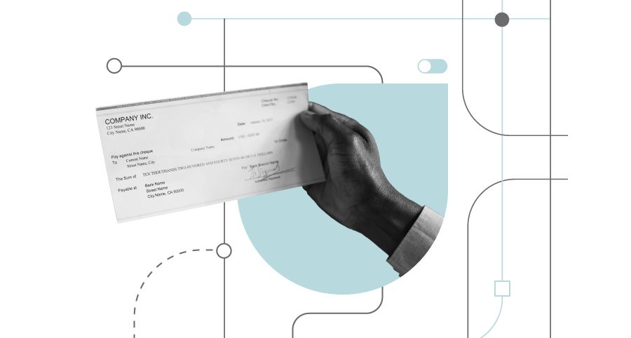 A hand holds a check that is ready for remote deposit capture.