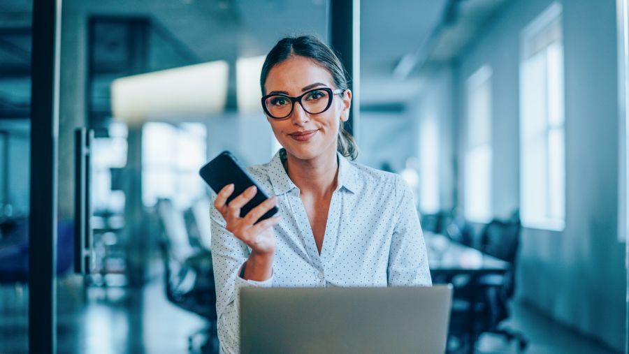 A woman holding a cell phone after using Branch Capture.